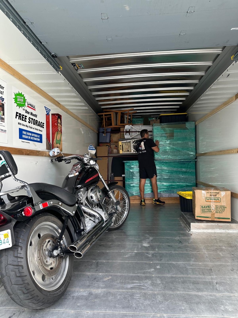 ProElite Movers crew carefully securing wrapped furniture inside a truck