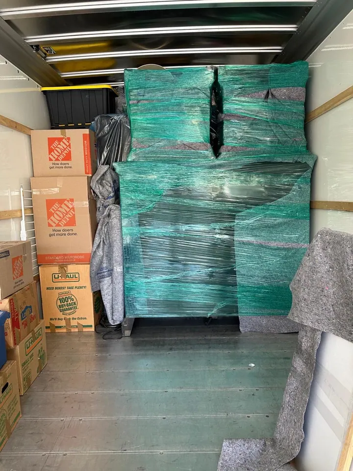 Wrapped furniture secured inside a moving truck
